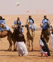 men riding a camel